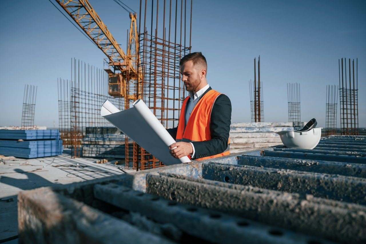 Engineer reviewing plans on a TRENX construction site